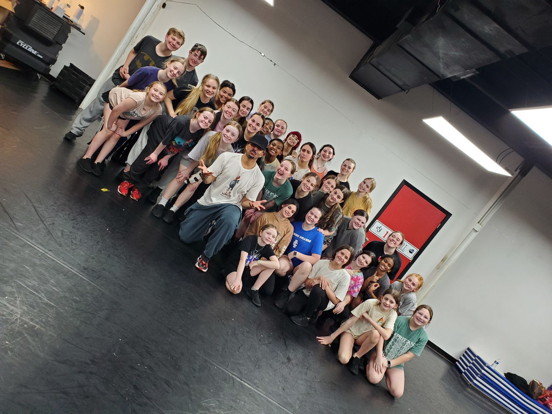 A large group of people are posing for a picture in a room.