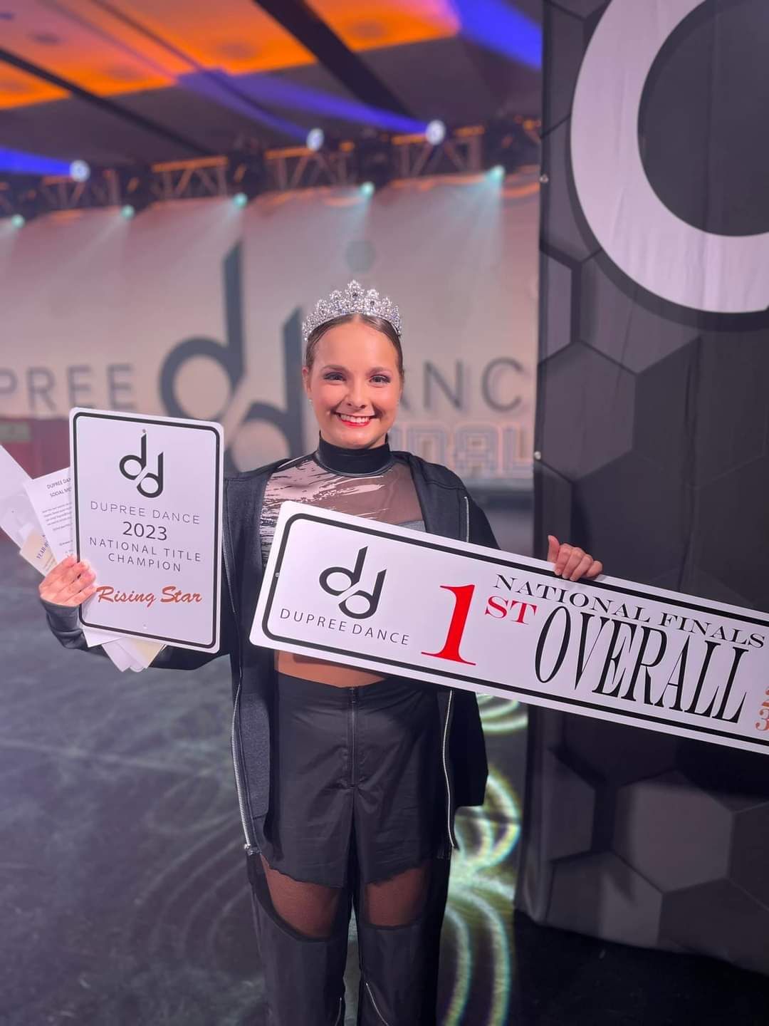 A woman is holding a sign that says 1st overall