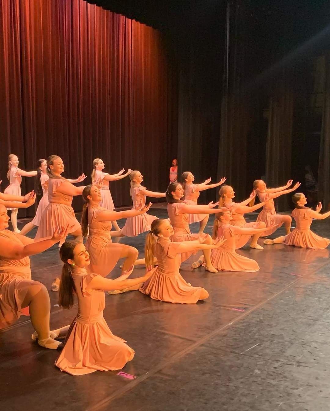 A group of young girls are dancing on a stage.