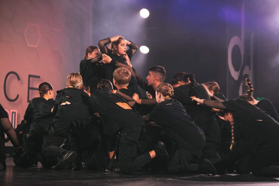A group of people are dancing on a stage.