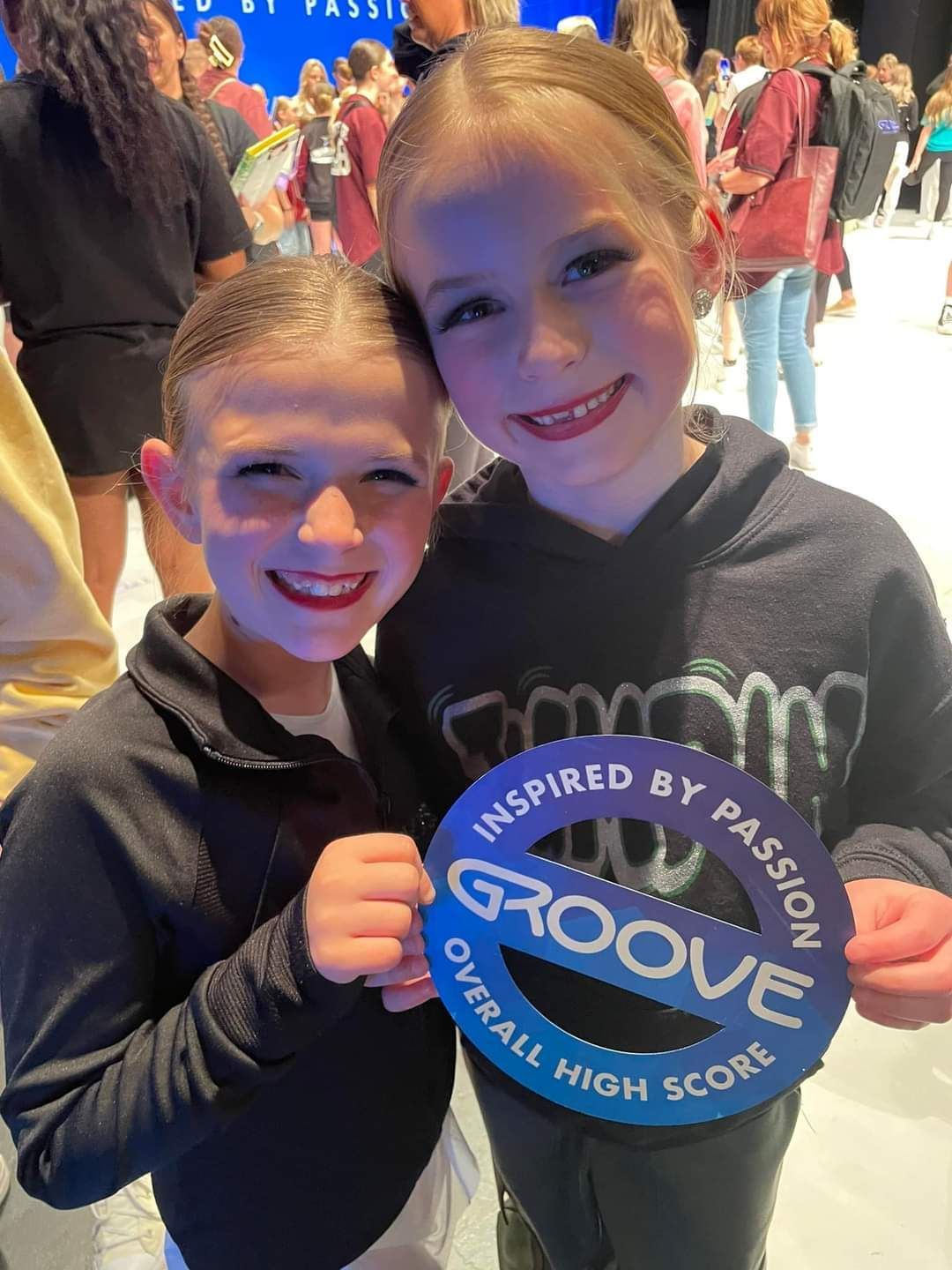 Two young girls are holding a sign that says