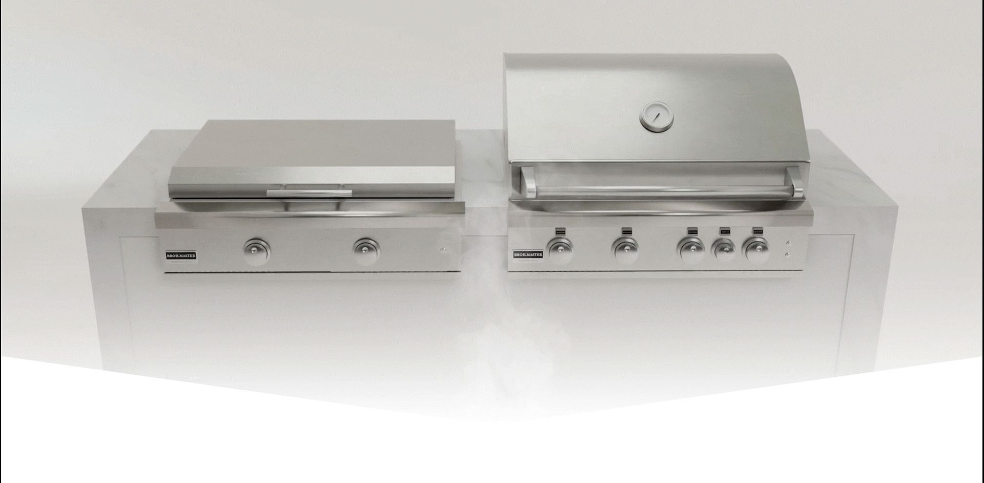 Two stainless steel gas grills on a clear countertop. One has a closed lid. The other has an open lid.