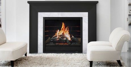 Two fireplaces with light gray stone surrounds, one with a log fire, the other a modern flame.