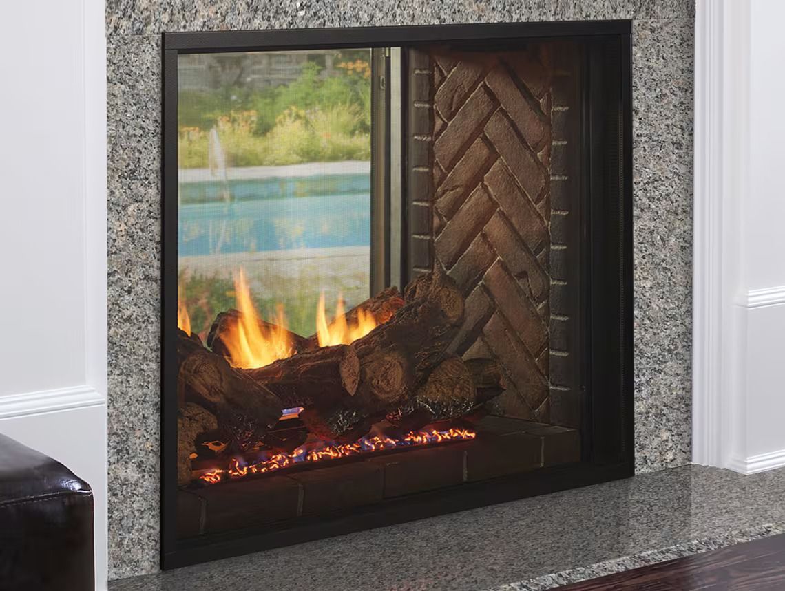 Lit gas fireplace with glass front, granite surround, and brick pattern interior.