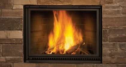 Fire burning in a fireplace behind a mesh screen; flames are yellow/orange.