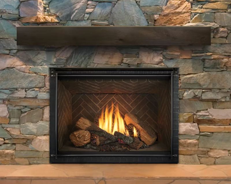 Fireplace with burning flames, stone surround, and wooden mantel.