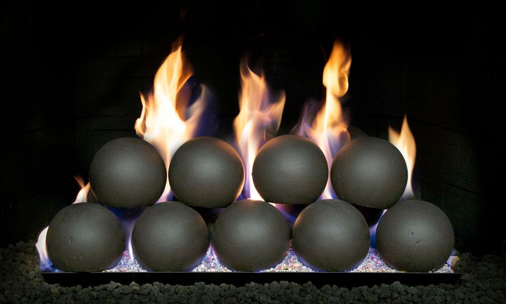 Fireplace with eight spherical, gray fire balls amid flames.