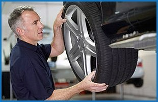 Mechanic installing tire and rim
