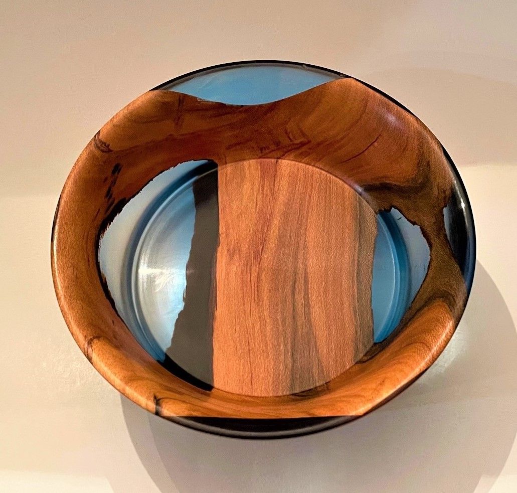 Wood and blue resin bowl, brown wood center, dark rim.