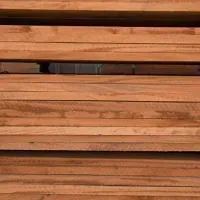 Stack of light brown wooden planks.