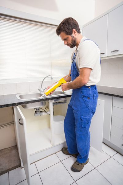 Man fixing kitchen sink