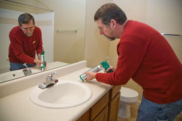 Plumber fixing bathroom sink
