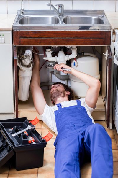 Plumber working on tubes