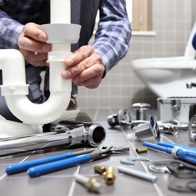 Learn More About New Construction and Remodels Plumber fixing pipes