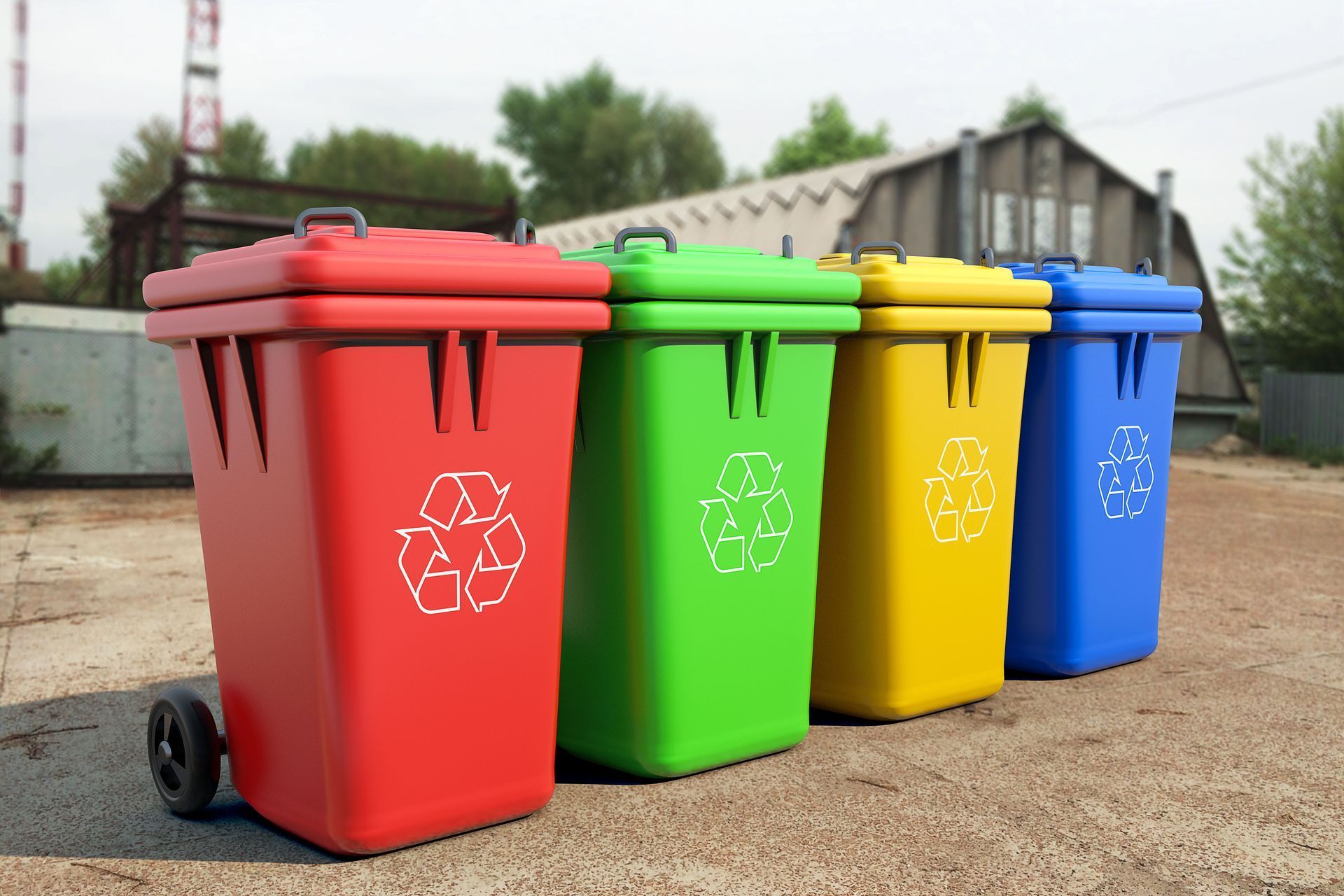 Four colorful recycling bins: red, green, yellow, and blue, with recycling symbols.
