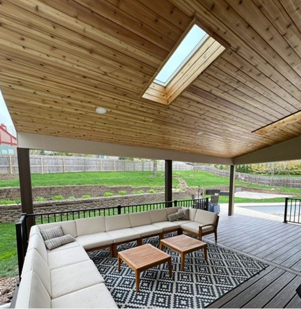A patio with a couch and a skylight in the ceiling