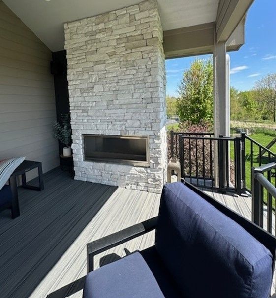 A patio with a fireplace and a chair
