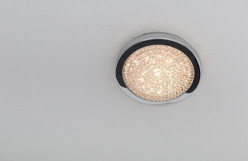 A round light with a black rim is hanging from the ceiling.