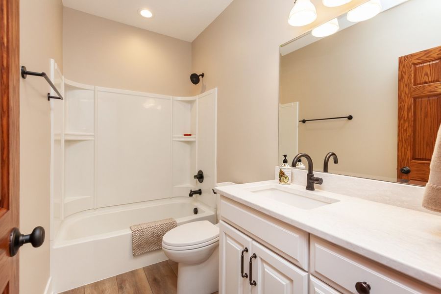 A bathroom with a toilet , sink , and bathtub.