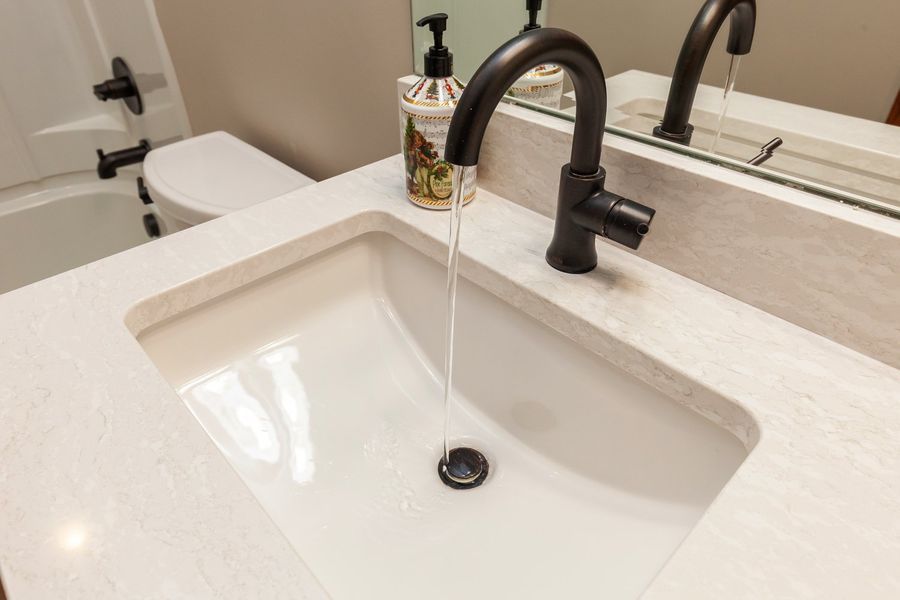 A bathroom sink with water running out of it.
