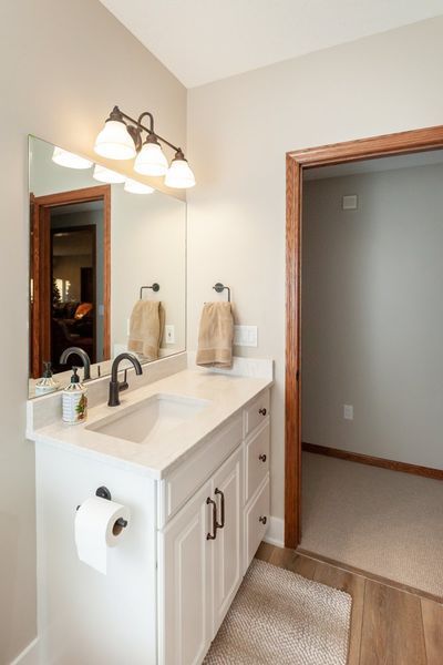 A bathroom with a sink and a mirror.