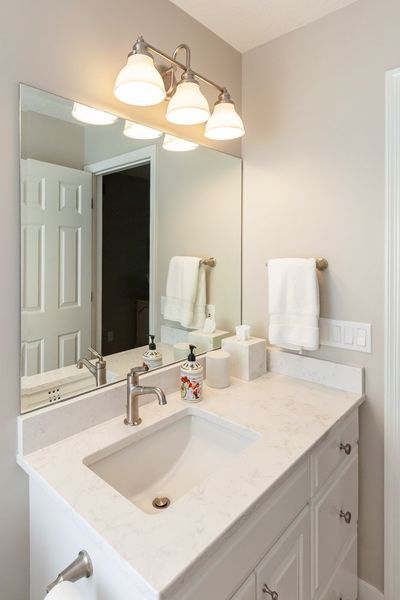A bathroom with a sink and a mirror