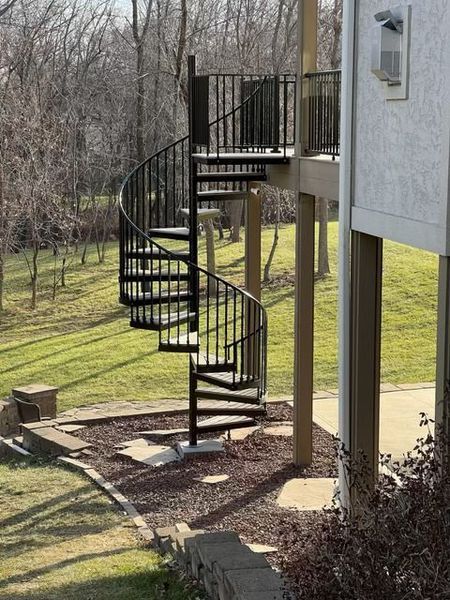 A spiral staircase on the side of a house