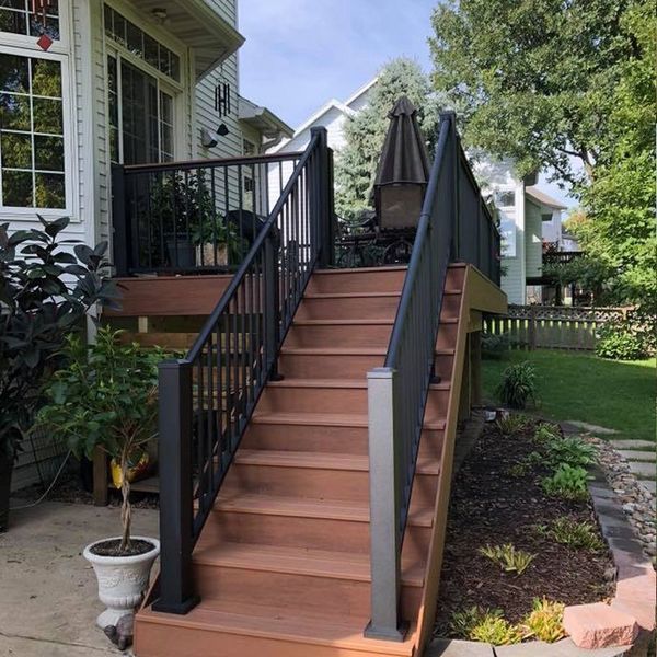 A wooden deck with stairs leading up to it