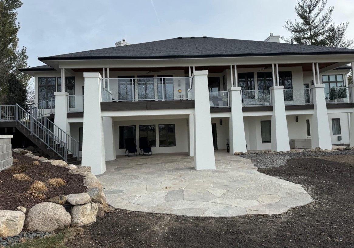 A large white house with a patio in front of it.