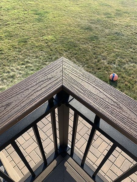 An aerial view of a deck with a ball in the grass.