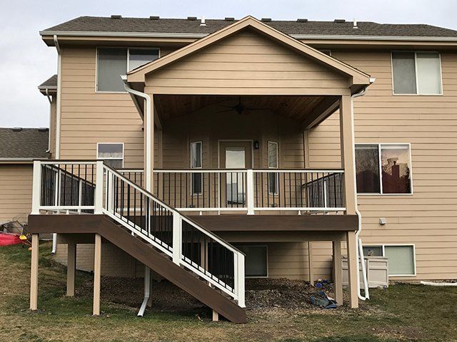 The back of a house with a deck and stairs