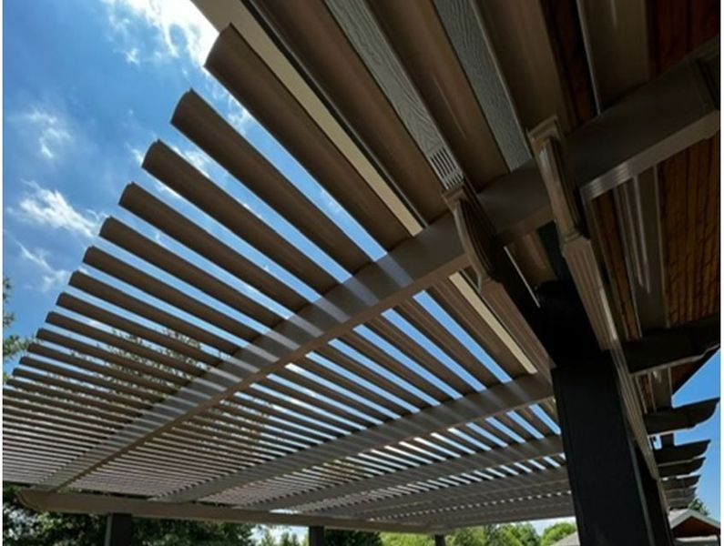 A pergola with a blue sky in the background