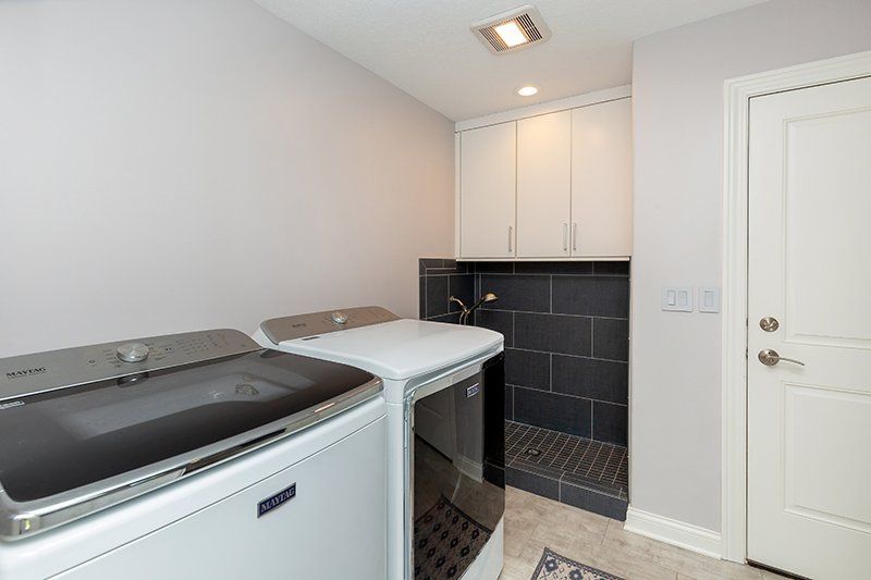A laundry room with a washer and dryer in it.