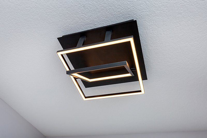 A ceiling light is hanging from the ceiling in a room.