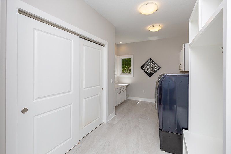 A laundry room with a washer and dryer and a sink.