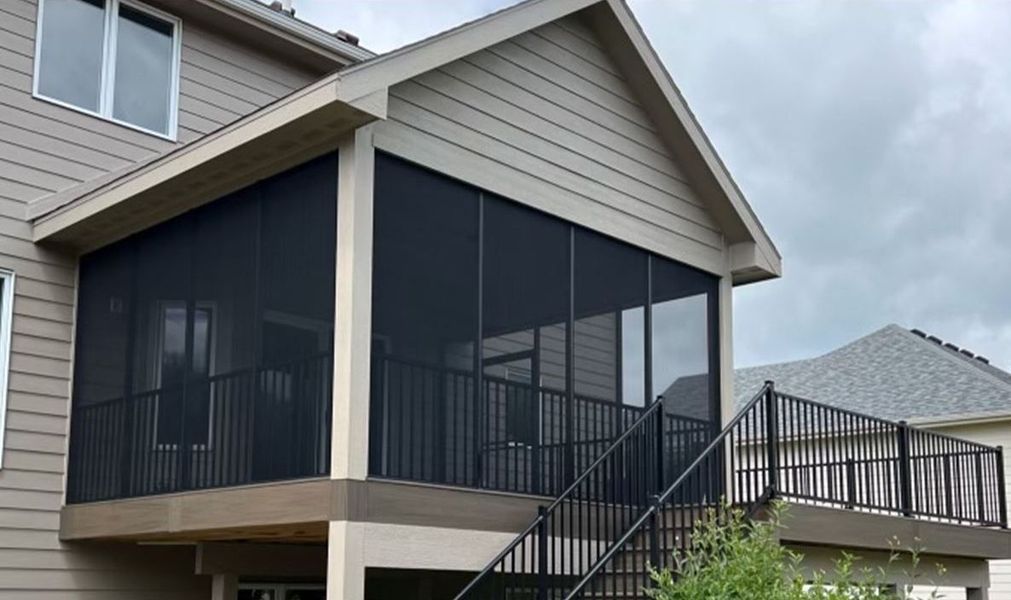 There is a screened in porch with stairs leading up to it.