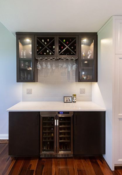 A kitchen with a wine cooler and a wine rack