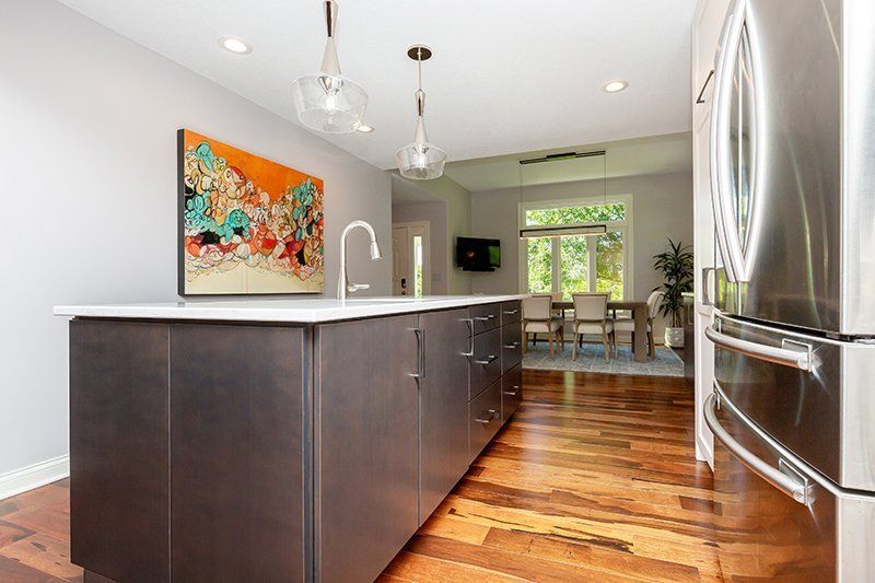 A kitchen with a large island and stainless steel appliances.