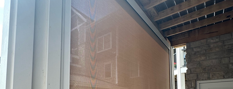 A close up of a window with a reflection of a building in it.