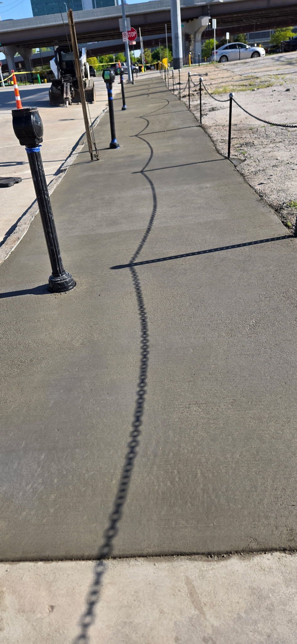 A concrete walkway is being built in a city.
