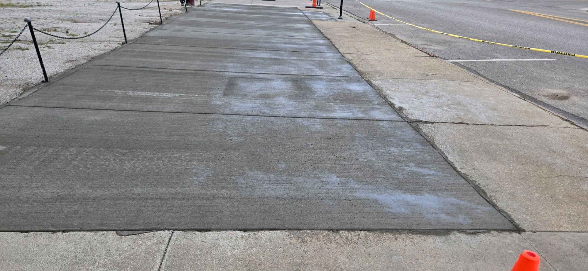 A concrete sidewalk is being built next to a road.