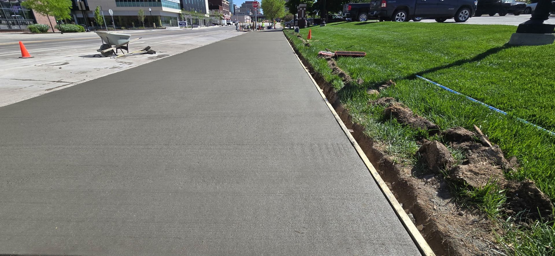 A concrete sidewalk is being built in a park.