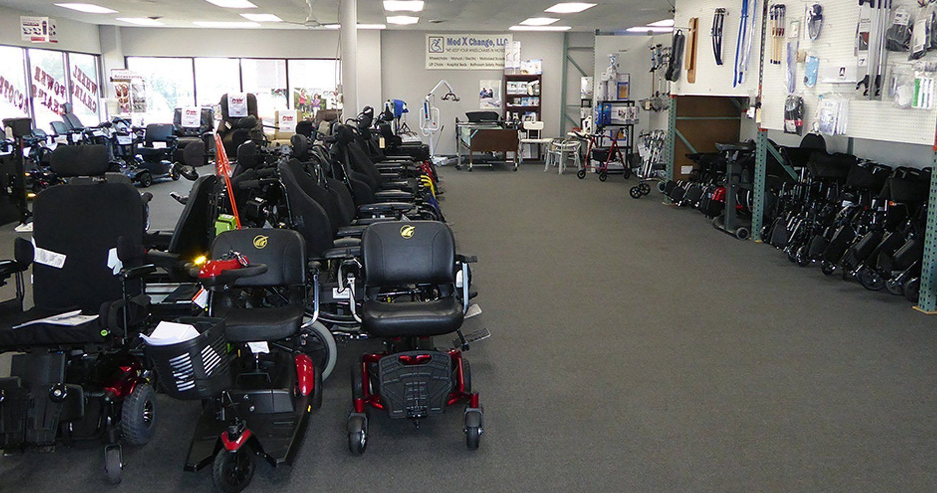 A showroom filled with wheelchairs and mobility scooters for sale.