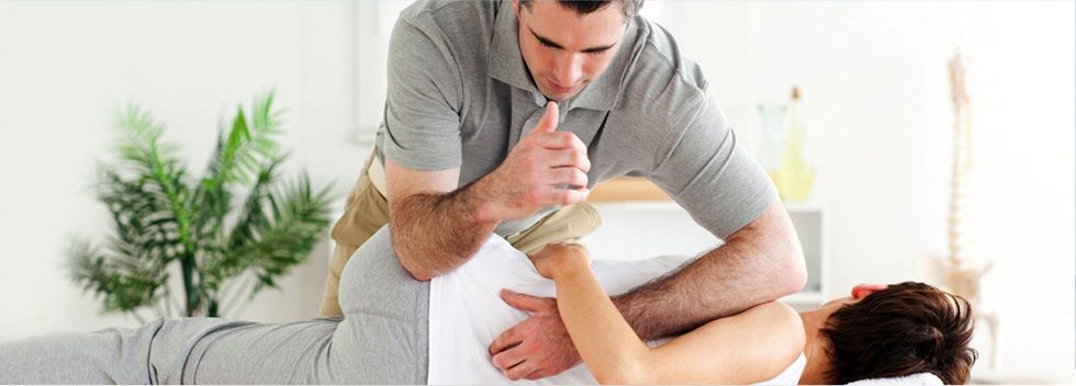 Man adjusting a woman's spine