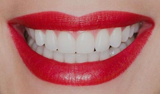 Happy patient checking her teeth