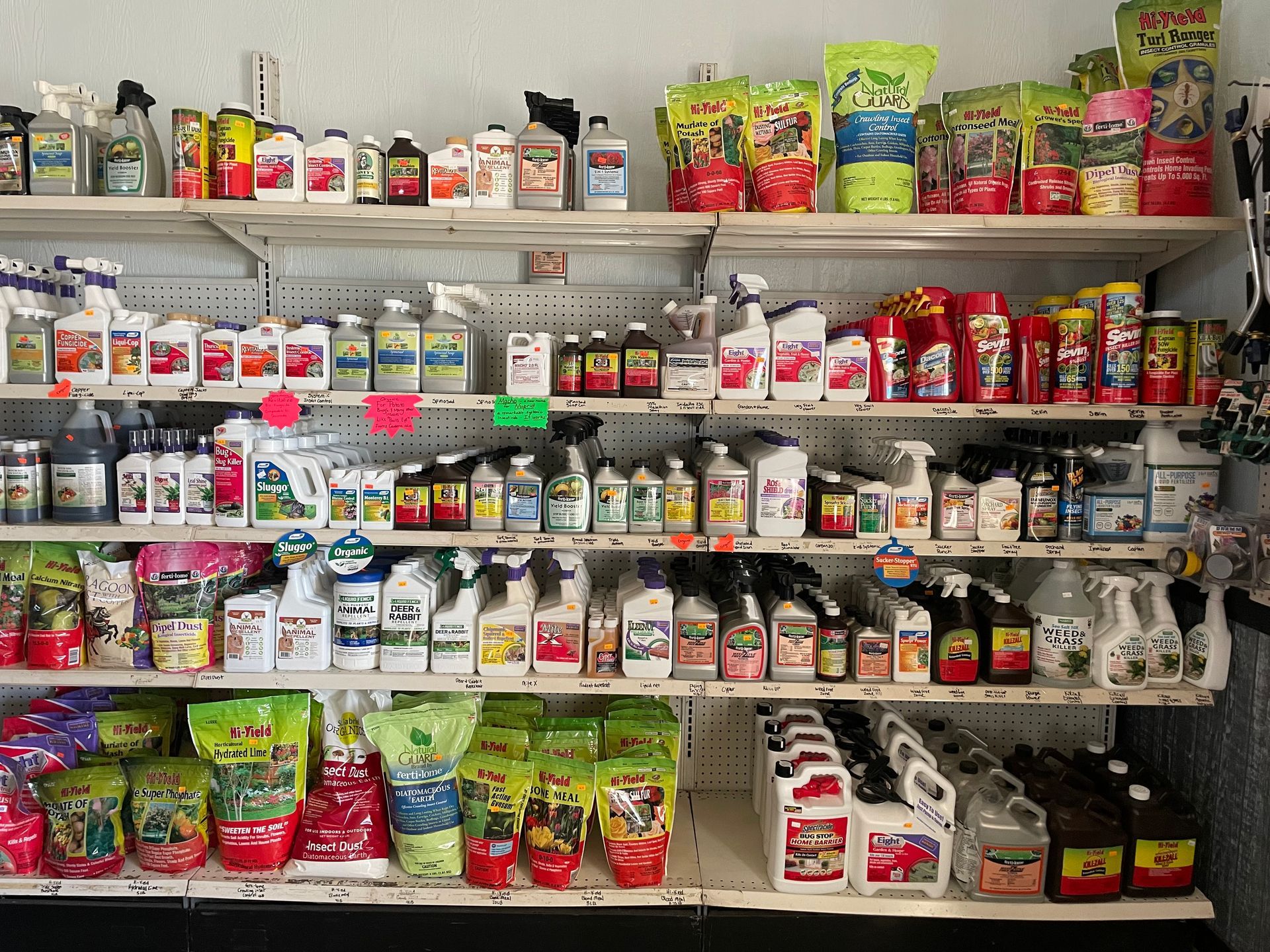 A store shelf filled with many different types of chemicals