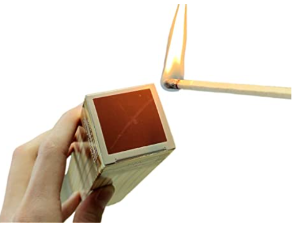 A person is lighting a match in a box