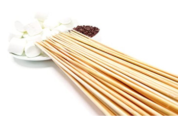 A bunch of chopsticks sitting on top of a plate of marshmallows.