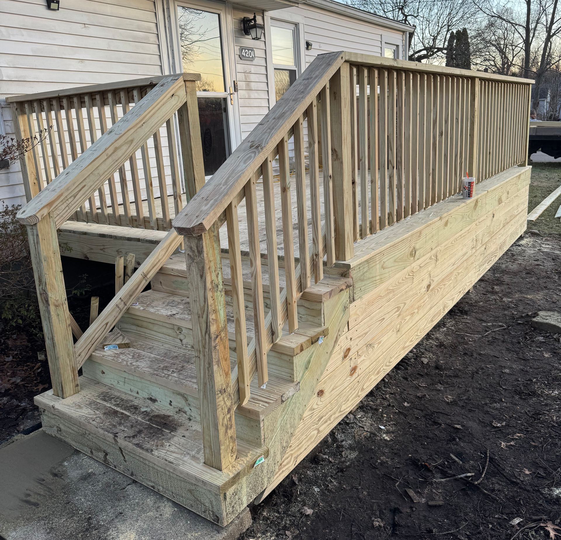 Wooden outdoor steps with railing.
