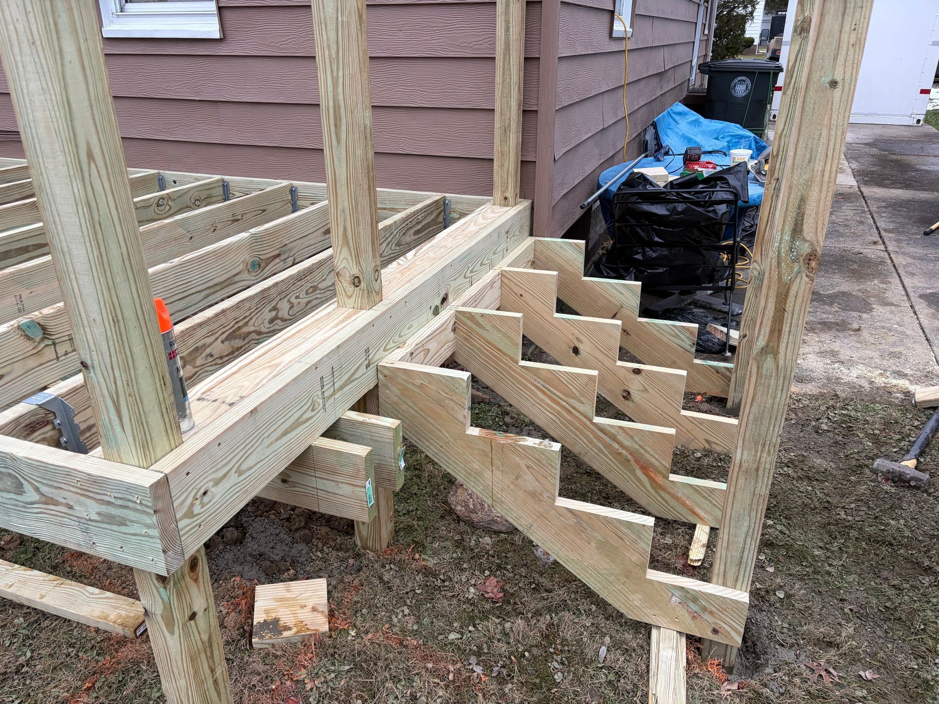 Wooden deck with stairs under construction outdoors